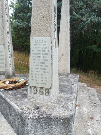 Monumento ai partigiani della Valnure, commemorazione con iscrizioni su piloni e un corone di fiori.