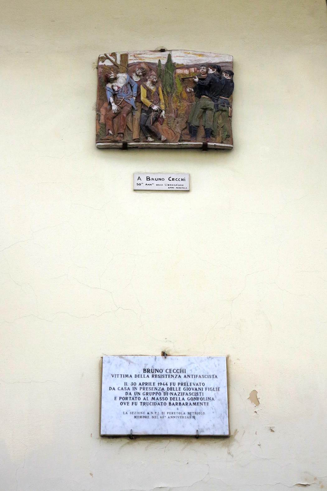 Bassorilievo dedicato a Bruno Cecchi, in memoria di vittime della Resistenza, con figure storiche e simboliche.