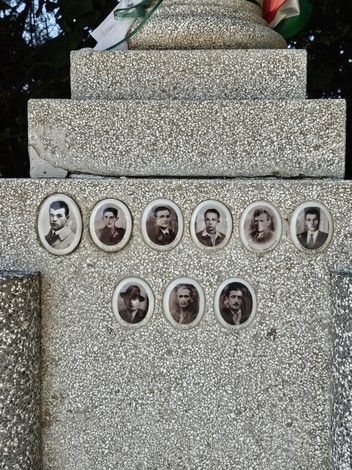 Cippo commemorativo con ritratti di martiri dell'eccidio all'Aeroporto di Forlì, simbolo di memoria storica.