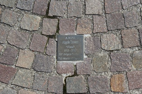 Pietre d'inciampo dedicate ai partigiani, in memoria di Angelo Trovetti, con dettagli sulla sua vita e impegno.