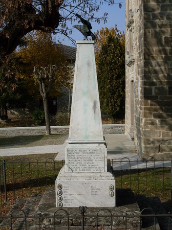 Monumento ai Caduti di Cavola, commemorativo con obelisco e sculture, situato in un'area verde del paese.