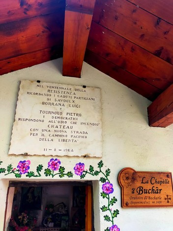 Lapide commemorativa dedicata ai partigiani Borrana e Tournoud, situata in un contesto storico.