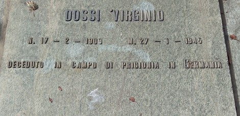 Targa commemorativa di Virgilio Dossi, con date di nascita e morte, in un contesto di memoria storica.