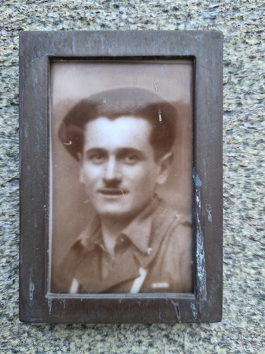Ritratti di uomini commemorati su una lapide, simbolo di memoria e rispetto.