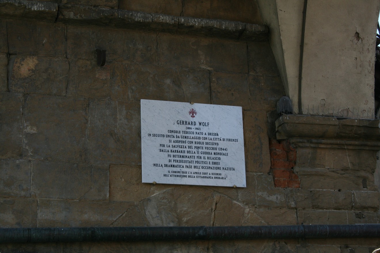 Lapide commemorativa dedicata al console Gerard Wolf, situata in un contesto storico significativo.