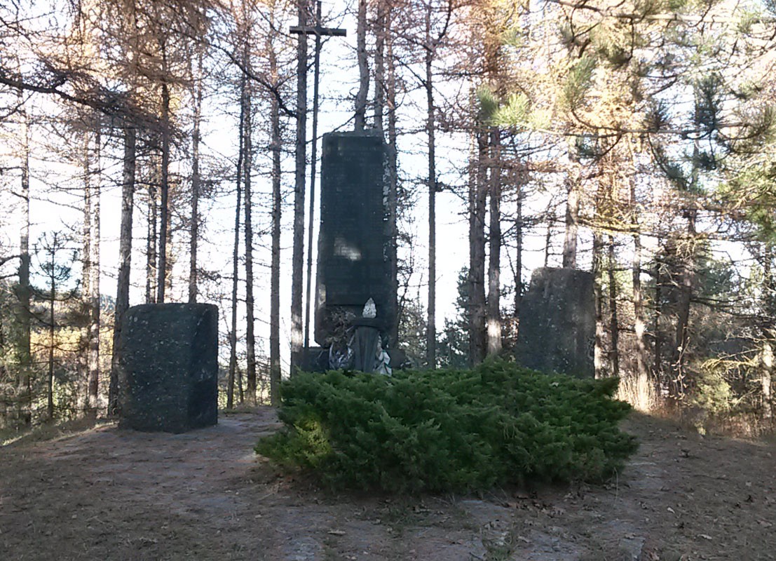 Monumento di Casa Piazza circondato da alberi, un luogo di memoria immerso nella natura.