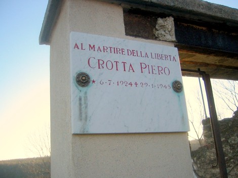 Lapide commemorativa dedicata a Crotta Piero, martire della libertà, situata in un contesto storico.
