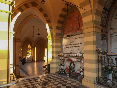 Sacrario dei caduti per la libertà di Carpi, un luogo di commemorazione con decorazioni e fiori in un ambiente architettonico.