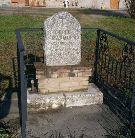 Cippo commemorativo dedicato a Giuseppe Marmiroli, situato in un'area verde.