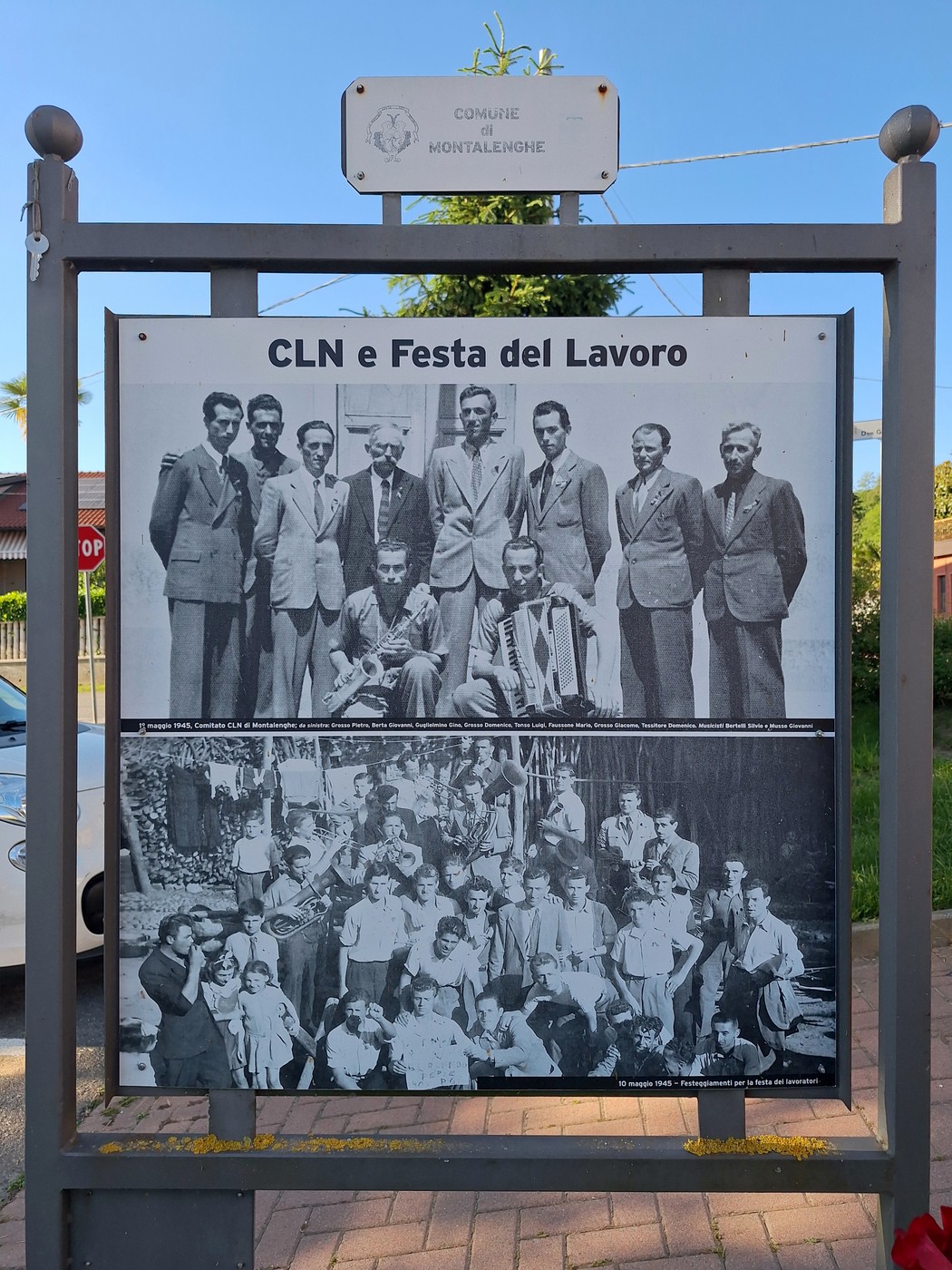 Pannello all'aperto con due foto storiche in bianco e nero e didascalie, titolo "CLN e Festa del Lavoro".