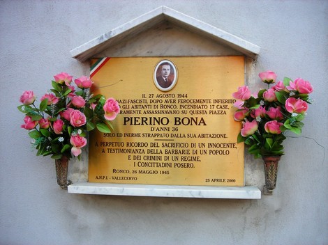 Targa commemorativa in memoria di Pierino Bona, vittima del nazifascismo a Ronco, con fiori decorativi.