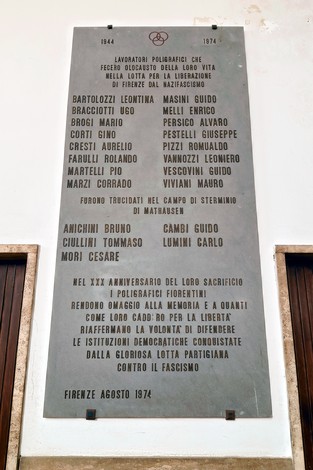 Lapide commemorativa dedicata ai poligrafici caduti per la libertà, con nomi e date storiche.