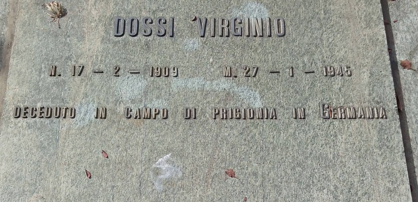 Targa commemorativa di Virgilio Dossi, con date di nascita e morte, in un contesto di memoria storica.