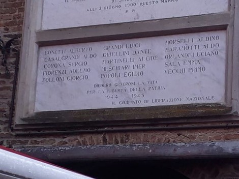 Lapide commemorativa dedicata ai caduti della Resistenza, con nomi di soldati e date significative.