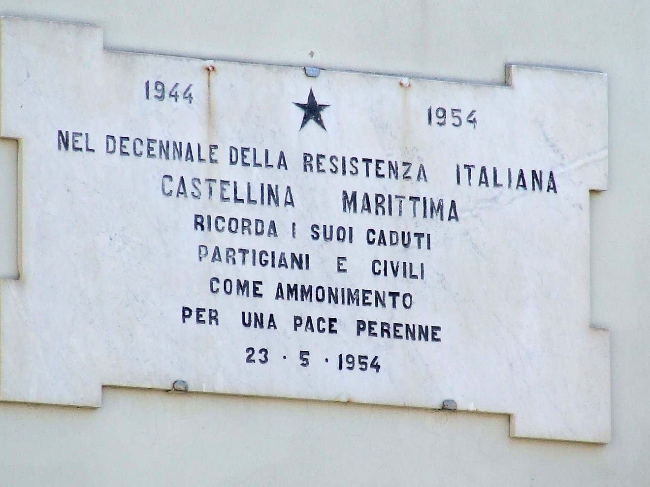 Lapide commemorativa del decennale della Resistenza italiana a Castellina Marittima, dedicata a partigiani e civili.