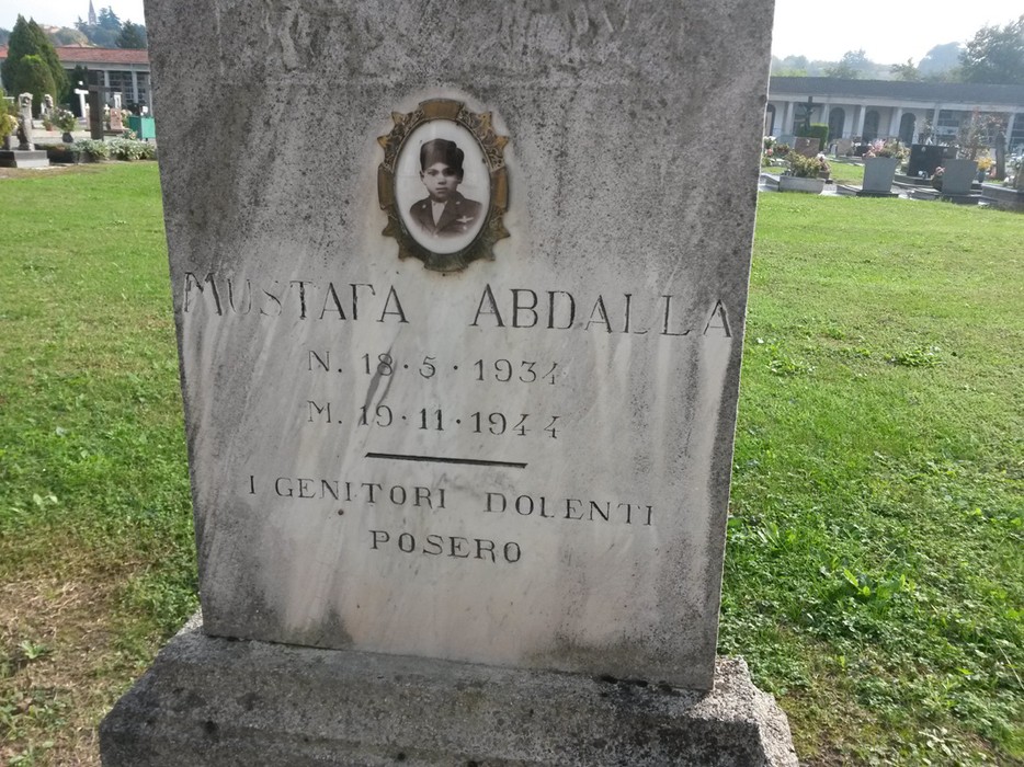 Tomba di Abdalla, monumento commemorativo in un cimitero, con foto e iscrizione in memoria del defunto.