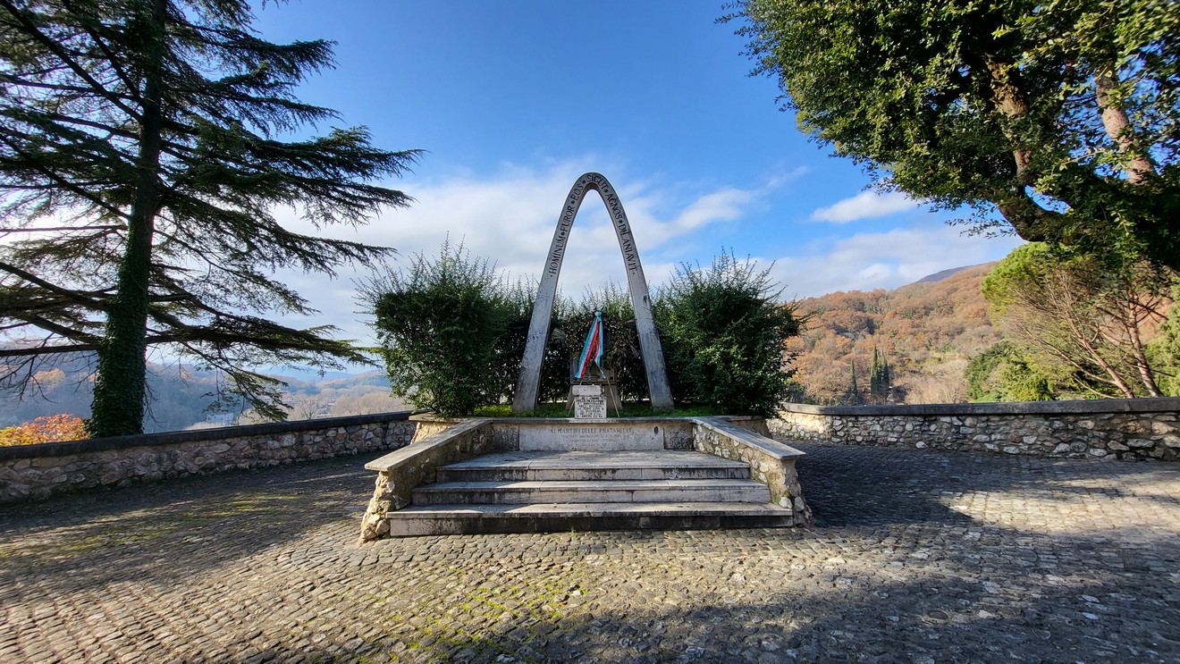 Monumento ai martiri delle Pratarelle, dedicato alla memoria dei caduti, immerso in un paesaggio naturale.
