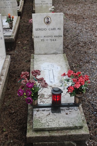 Tombe con fiori e lanterna commemorativa, dedicate ai caduti per la Libertà.
