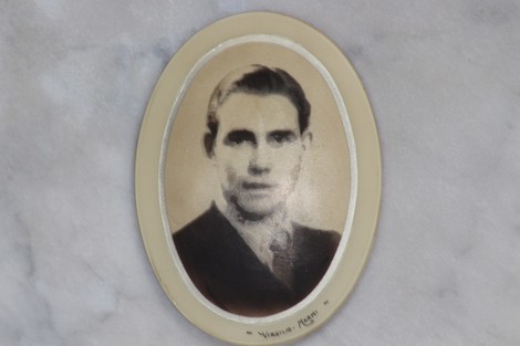 Ritratto di un giovane uomo, incastonato in una cornice ovale, in memoria dei caduti per la Liberazione.