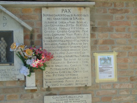 Lapidi commemorative delle vittime del bombardamento di Santa Marta, con fiori decorativi e dedica.
