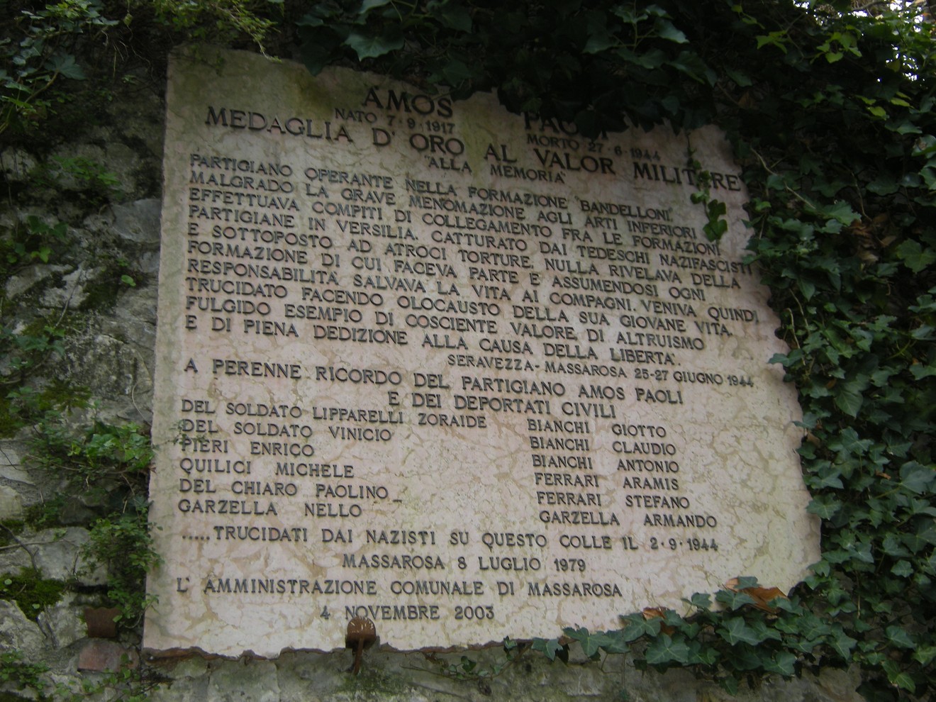Lapide commemorativa dedicata a Paoli e ai deportati, con nomi e onorificenze in memoria delle vittime.