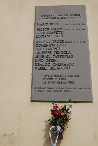 Lapide commemorativa dedicata ai partigiani caduti a Valmozzola, con nomi e date di caduta.