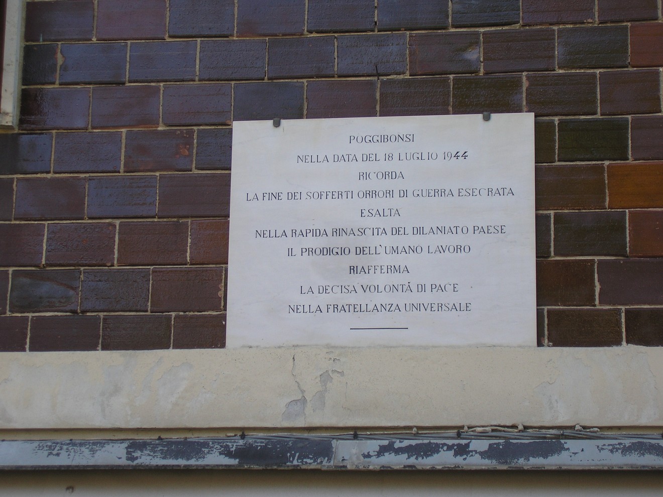 Lapide commemorativa della Liberazione nel 1946 a Poggibonsi, simbolo di pace e rinascita.