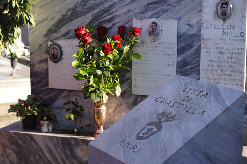 Sepolcri di Camurri, Saletta e Catellani con fiori rossi e lapidi in marmo, in un ambiente di commemorazione.
