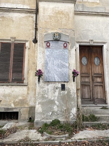 Lapide commemorativa dedicata alla Resistenza, situata a Collegno, su un muro di un edificio storico.