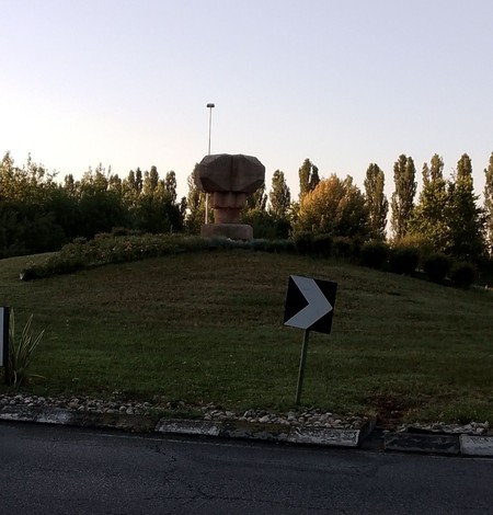 Monumento ai martiri di Marzabotto su un verdeggiato rilievo, circondato da alberi e vegetazione.