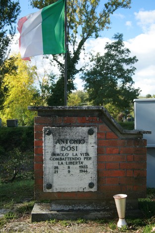 Cippo commemorativo dedicato ad Antonio Dosi, con bandiera italiana, in ricordo del suo sacrificio per la libertà.