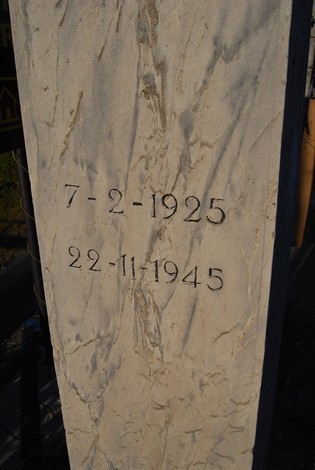 Cippo commemorativo con date significative, simbolo di memoria storica.