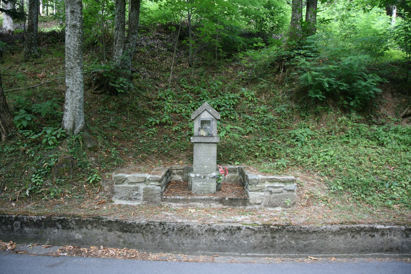 Tabernacolo in stile ducceschi, immerso nel verde, simbolo di devozione e tradizione locale.