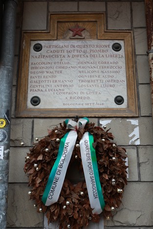 Lapide commemorativa con corona di alloro, dedicata ai caduti della Libertà di Crocetta a Bologna.