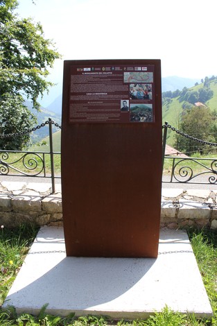Pannello informativo sulla Strada della battaglia di Fonteno immerso nella natura verdeggiante.