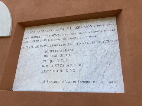 Lapide commemorativa dedicata ai caduti per la libertà, con nomi incisi e una significativa dedica.
