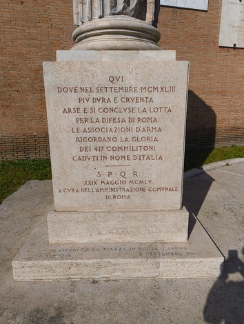 Cippo commemorativo dedicato ai caduti nella difesa di Roma, situato in un contesto storico significativo.