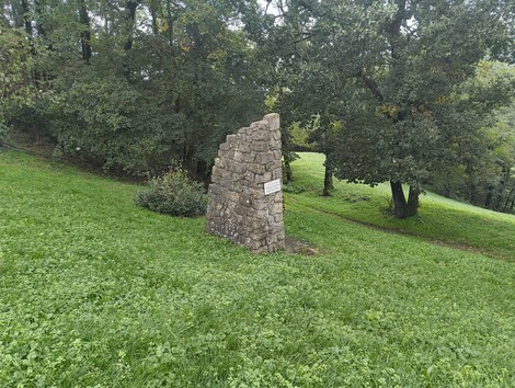 Monumento ai caduti di San Giovanni di Sotto, situato in un'area verde e tranquilla, circondato da alberi.